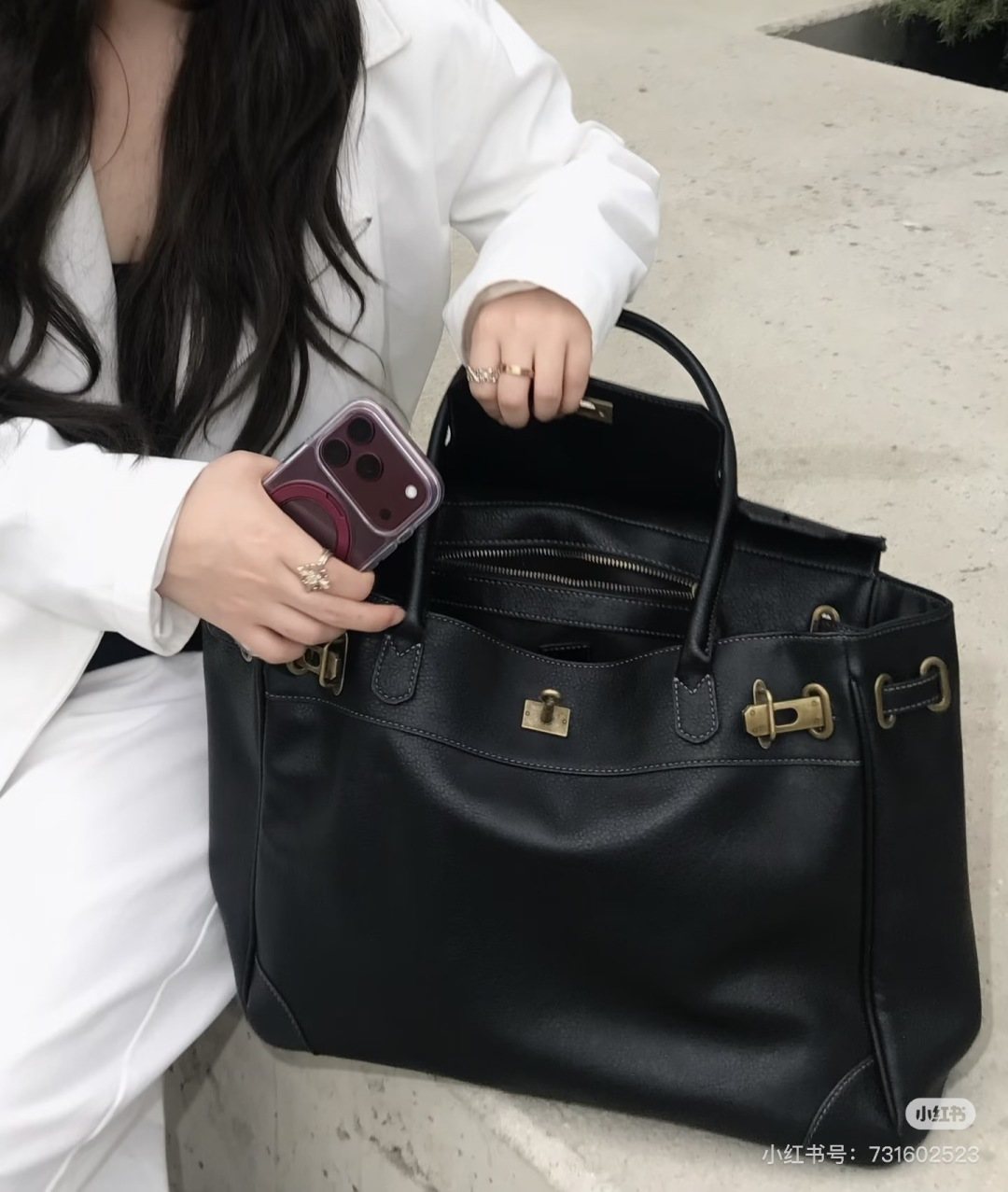 Black Folded-Flap Handbag with Gold-Tone Hardware — model